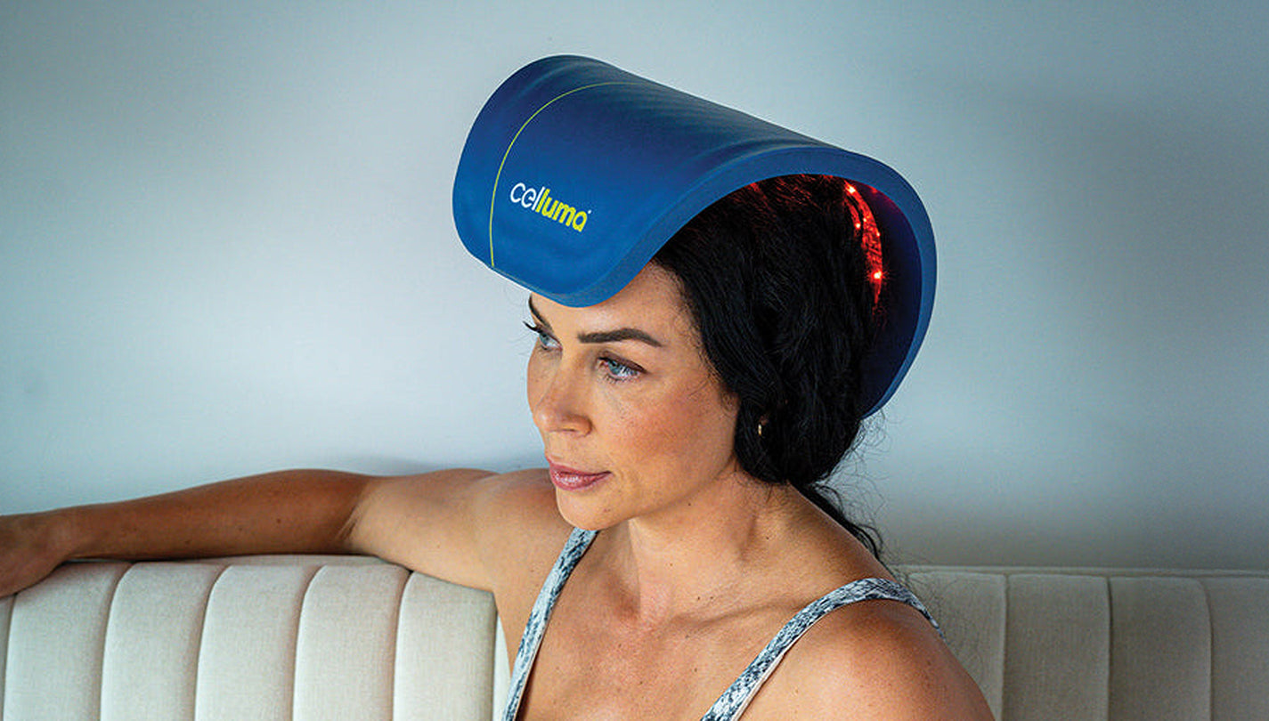 A lady using Celluma led red light therapy penetrating the scalp for hair loss.