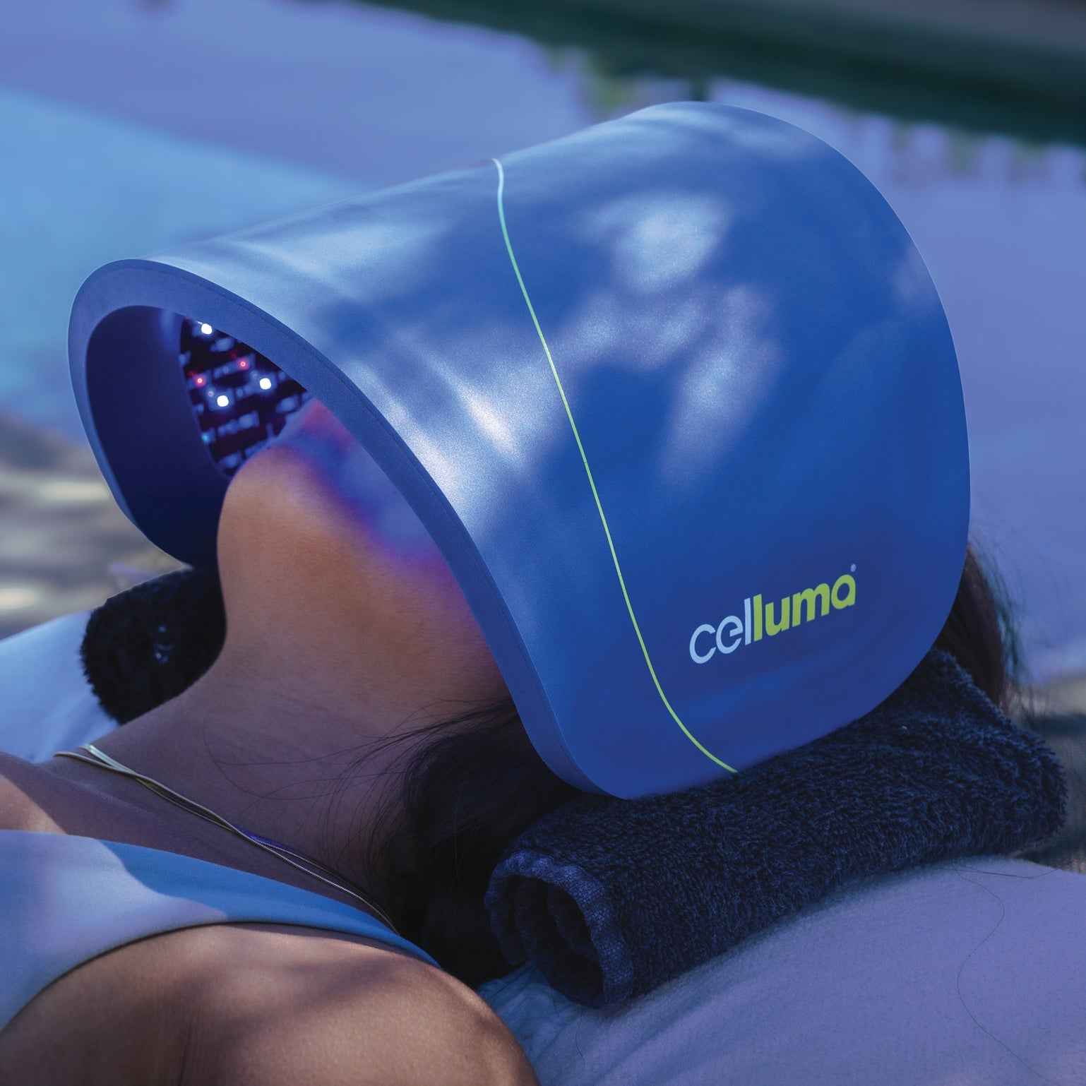 Woman using Celluma HOME LED red light therapy for skin rejuvenation, boosting collagen and elastin.