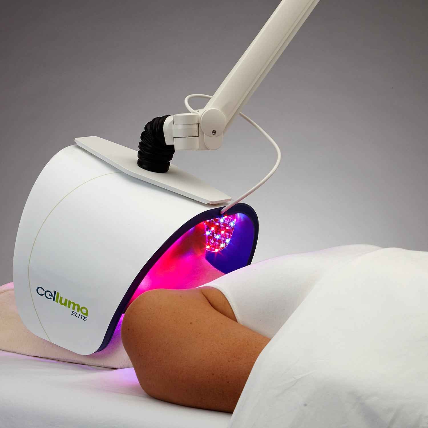 A woman using Celluma  ELITE Professional grade LED Red Light Therapy for acne.