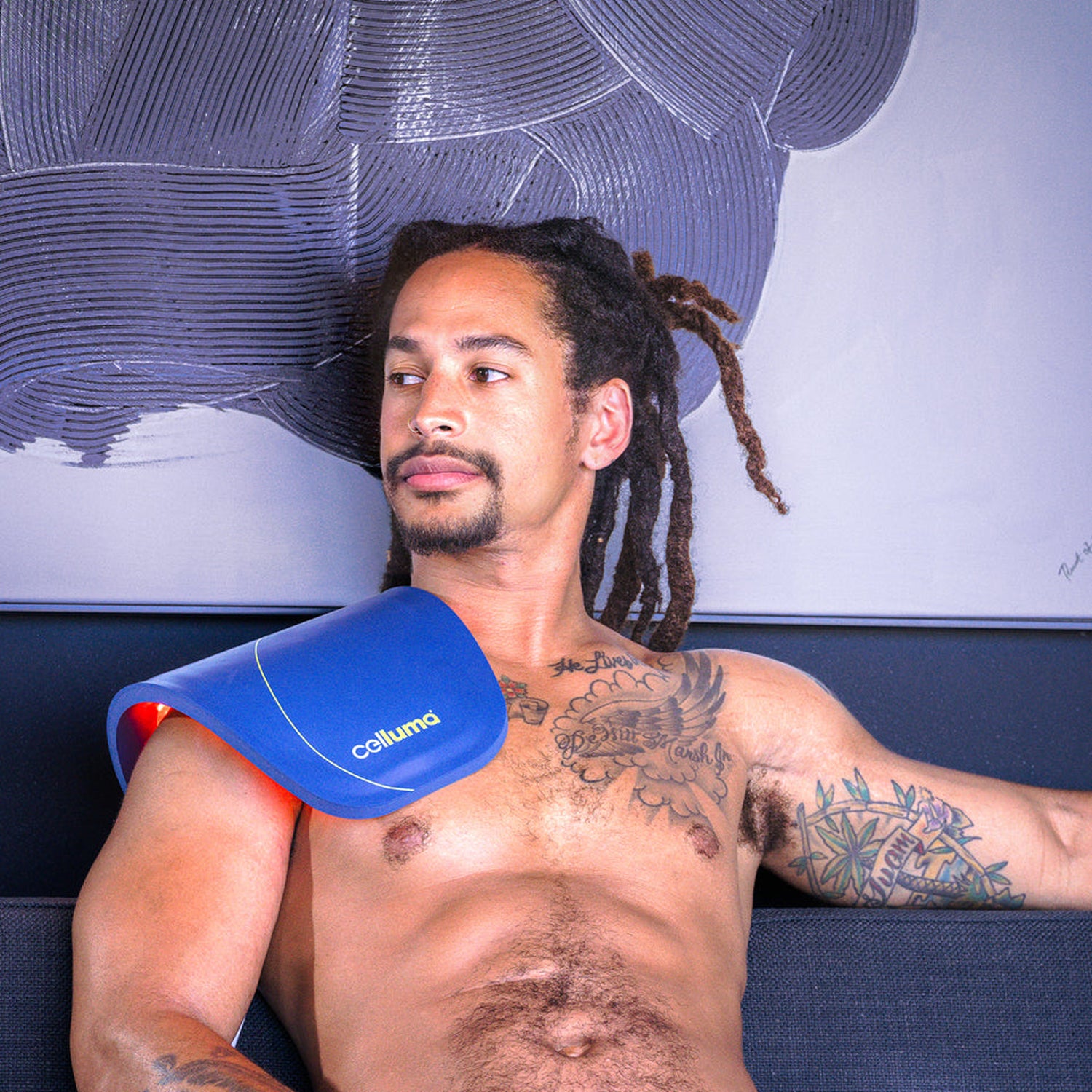 Man using Celluma Lite LED Red Light Therapy on his shoulder for frozen shoulder and pain relief. 