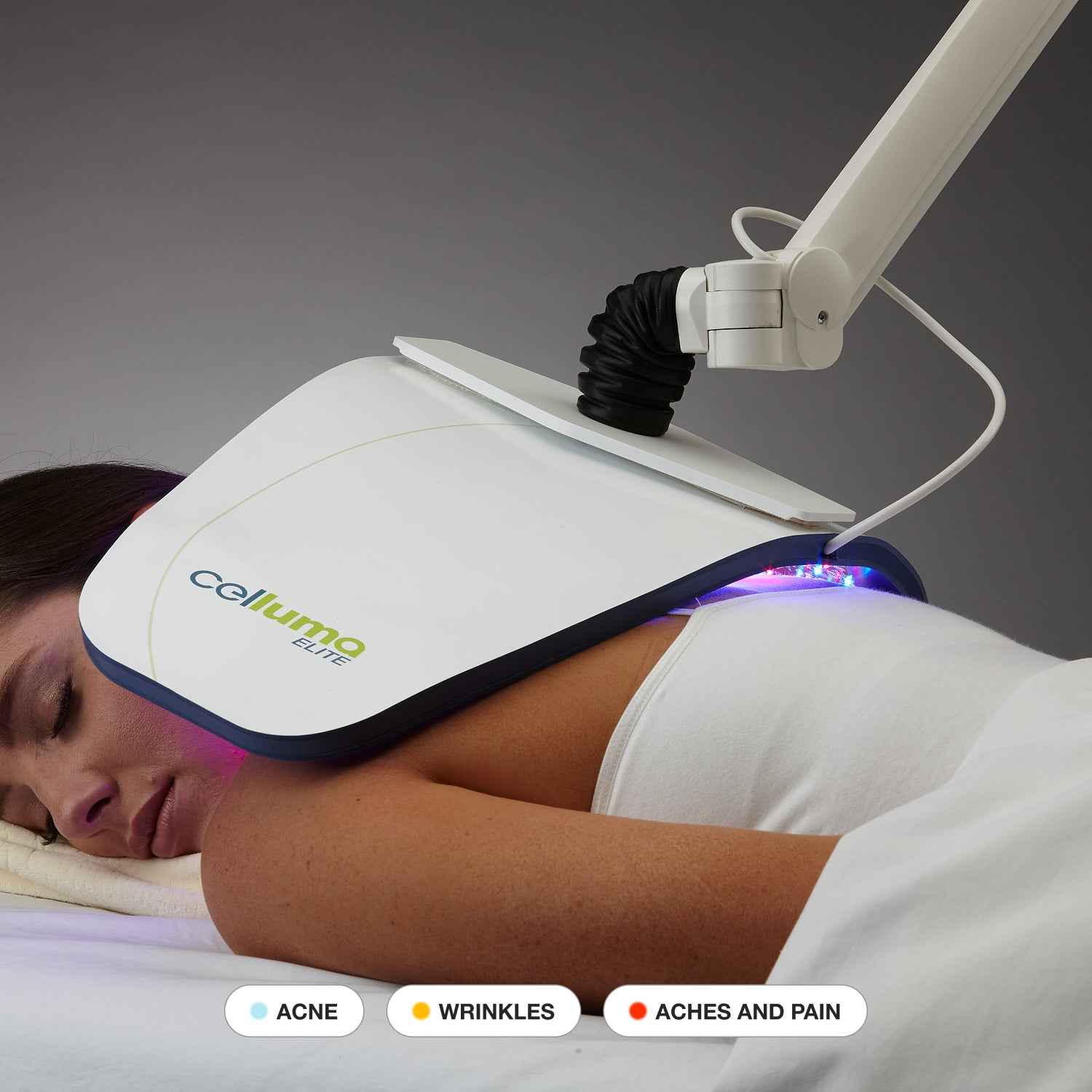 Patient receiving Celluma ELITE clinical LED red light therapy for anti-aging and acne treatment.